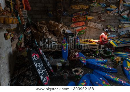 Ubud/bali-april 27 2019: Two Female Craftsmen From Ubud Were Making Mini Surf Boat Crafts That Were