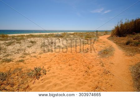 Beautiful Landscape With Red Rocks On Praia Da Falesia - Falesia Beach In Algarve, Portugal.