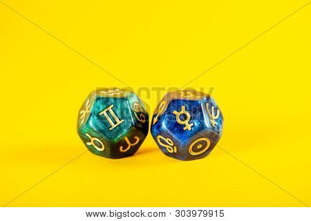 Astrology Dice With Zodiac Symbol Of Gemini May 21 - Jun 20 And Its Ruling Planet Mercury On Yellow 
