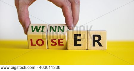 Loser Or Winner Symbol. Businessman Hand Turns Cubes And Changes The Word 'loser' To 'winner'. Beaut