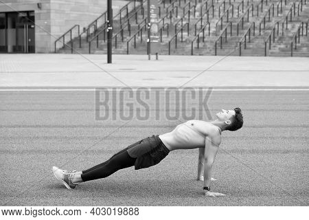 Sporty Man Making Back Plank Exercise. Guy In Reverse Plank Exercise. Yoga Fitness Man Stretching Bo