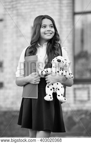 We Teach You Learn. Happy Child Hold Toy And Books Outdoors. Back To School Essentials. Primary Educ