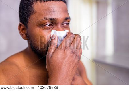 African American Man Snot Symptom Feeling Bad Stay At Home Looking At Mirrror In Bathroom