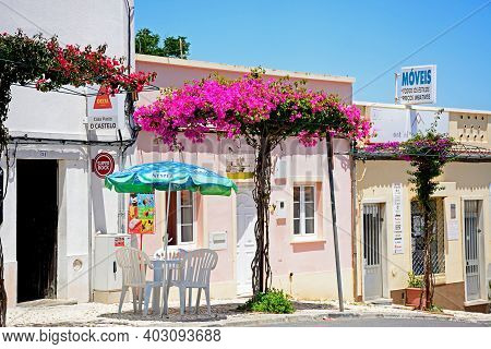 Castro Marim, Portugal - June 11, 2017 - Pavement Cafe Along A Town Street With Pretty Bougainvillea