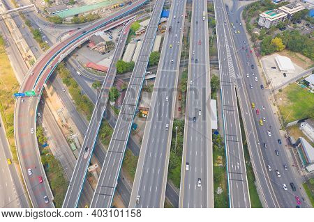 Aerial View Of Cars Driving On Highway Or Moterway. Overpass Bridge Street Roads In Connection Netwo