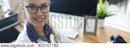 Top View Of Smiling Nurse Looking At Camera With Happiness And Calmness. Device For Measuring Pressu