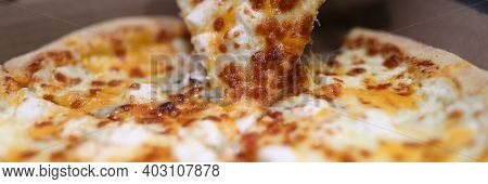 Close-up Of Persons Hand Taking Delicious Slice Of Oven Baked Pizza. Bacon Sausages Double Cheese An