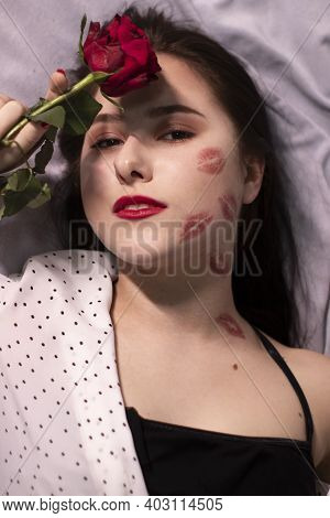 Sexy Brunette Woman With Kisses, Lipstick Marks On Her Face And Neck, With Red Rose. Girlfriend, Dat