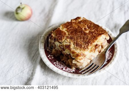 Apple And Cheese Cobbler Crisp. Cobbler Or Crumble Dessert With Apples On Plate On Beige Linen Table
