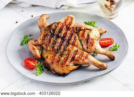 Grilled Chicken Tabaka On Blue Plate. Georgian Cuisine.