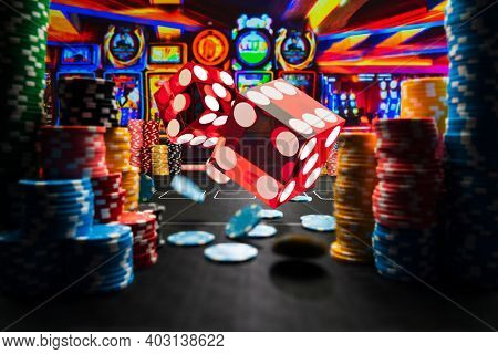 Casino rolling dice and chips on the gamblingtable
