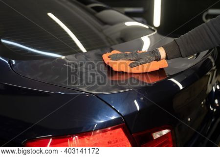 Car Polishing Process. 
Detailing Master Applies Wax For Polishing On The Vehicle Body