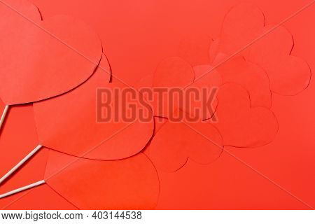 Preparing For A Romantic Evening. Lots Of Paper Hearts On A Red Background. Valentines Day On Monoch