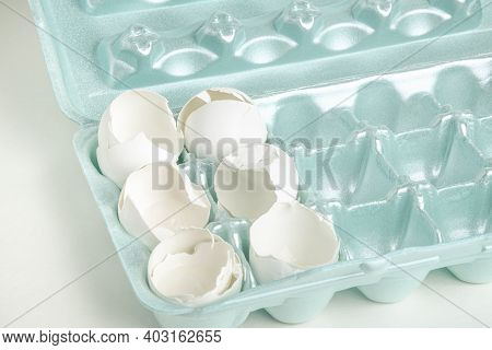 A Close-up Of A Set Of Cracked White Egg Shells Individually Nestled On Cores Of Styrofoam Tray.