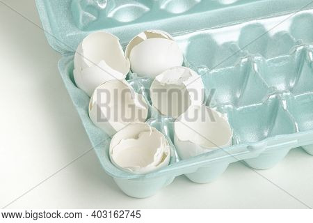 A Close-up Of A Set Of Cracked White Egg Shells Individually Nestled On Cores Of Styrofoam Tray.