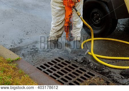 Closeup Of Asphalt Demolishing With Pneumatic Plugger Jackhammer