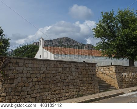 View Of Old White Red Roof Church Chiesa Di Santa Maria Over Stone Wall In Small Coastal Village San