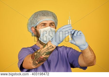 Vaccine Development. Man Nurse With Coronavirus Vaccine In Syringe. Medical Injection. Bearded Docto