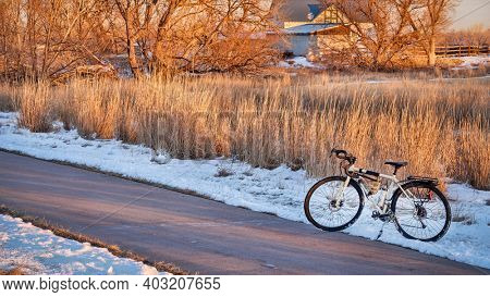 touring bicycle in late fall or winter scenery in sunset light on a bike trail in Fort Collins, northern Colorado, recreation and commuting concept