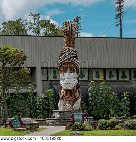 Cherokee, United States: September 13, 2020: Cherokee Carving With Covid Mask Reminds Residents And 