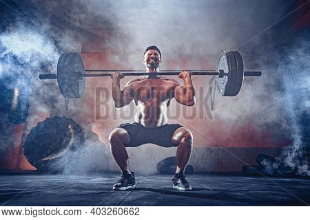 Muscular Fitness Man Doing Deadlift A Barbell Over His Head In Modern Fitness Center. Functional Tra
