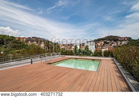 Empty Rooftop With Swimming Pool. View To A City And Mountain