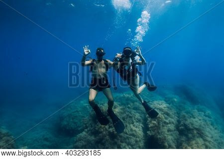 August 20, 2020. Anapa, Russia. Couple Of Scuba Divers Glides Underwater In Transparent Blue Sea. Sc