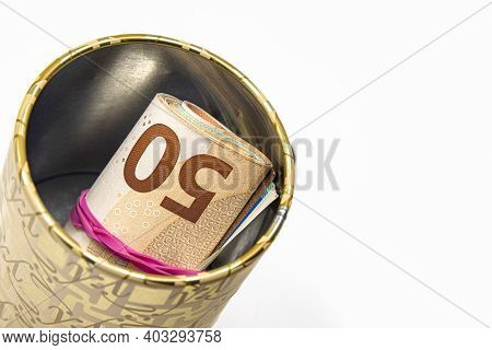 Metal Piggy Bank With Euro Symbols For Saving Money. On A White Background With Euro Banknotes. Savi