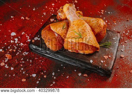 Top View.convenience Food,pree Cooked.chicken Marinated Dramstick On A Background Of Red Paprika. Ra