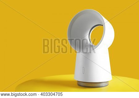 Modern Electric Fan On Yellow Table. Space For Text