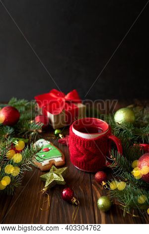 Hot Christmas Tea With Gingerbread Cookie On Wooden Table. Top View. New Year And Christmas Celebrat