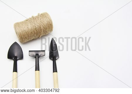 Garden Tools: Shovel, Rake, Rope-twine, Isolated On A White Background. Seeds And Home Gardening. Gr