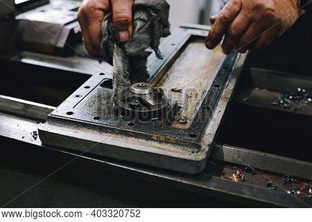 Service And Repair Of Machine Tools In A Machine Shop Or Workshop. These Are The Hands Of A White Ma