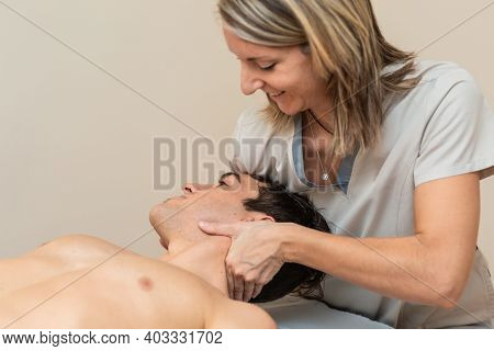 Physiotherapist Does Session To Man. Cervical Manipulation, Trapezium Stretch