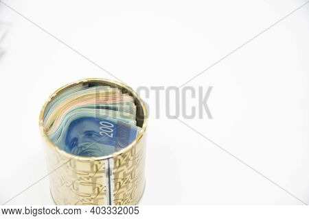 Metal Piggy Bank With New Israel Shekel Symbols For Saving Money. On A White Background With Nis Ban