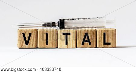 Text Vital Made From Wooden Cubes. White Background