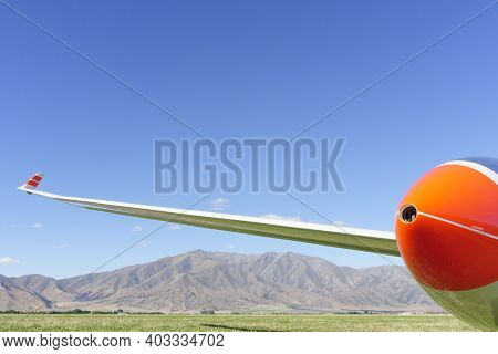 Blue Sky And Mountains Of South Island Under Wing Of Glider On Airfield. In New Zealand.