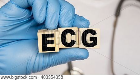 Ecg Electrocardiography Electrocardiogram - Word From Wooden Blocks With Letters Holding By A Doctor