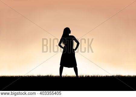 The Silhouette Of A Strong, Beautiful Woman Stands Isolated Against A Sunset In The Sky Background.