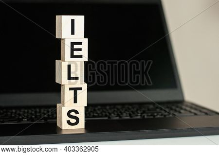 Ielts - Short For International English Language Testing System - Text Written On Wooden Block On Co