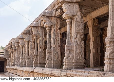 Hampi, Karnataka, India - November 5, 2013: Vijaya Vitthala Temple. Beige Stone Row Of Sculpted Pill