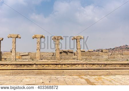 Hampi, Karnataka, India - November 5, 2013: Vijaya Vitthala Temple. Remains Of Brown Stone Wall Pill
