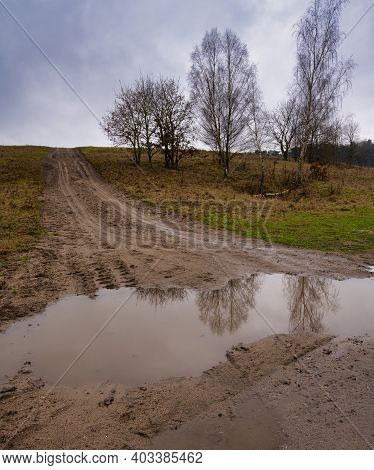 A Muddy Puddle And A Dirt Road At A Moor. Picture From Revingehed, Scania County, Sweden