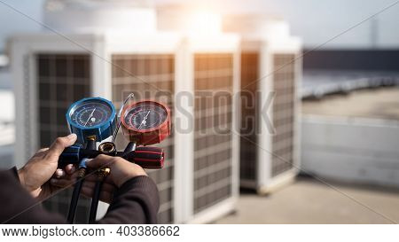 Air Repair Mechanic Using Measuring Equipment For Filling Industrial Factory Air Conditioners And Ch
