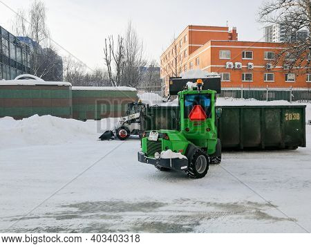 Moscow. Russia. January 15, 2021. Small Front-end Loaders Clear Snow From The Street And Load Into A