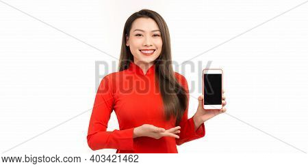 Asian Woman In Ao Dai Tranditional Dressing Pointing At Empty Smart Phone