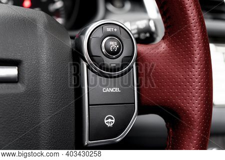Cruise Control Buttons On The Red Perforated Leather Steering Wheel Of A Modern Car.  Car Interior D