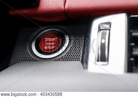 Car Dashboard With Focus On Red Engine Start Stop Button. Modern Car Interior Details. Start/stop Bu