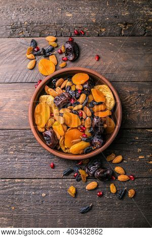 Assortment Of Nuts And Dried Fruits. Dried Fruits And Nuts Mix In A Wooden Bowl. Assortment Of Candi