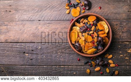 Assortment Of Nuts And Dried Fruits. Dried Fruits And Nuts Mix In A Wooden Bowl. Assortment Of Candi